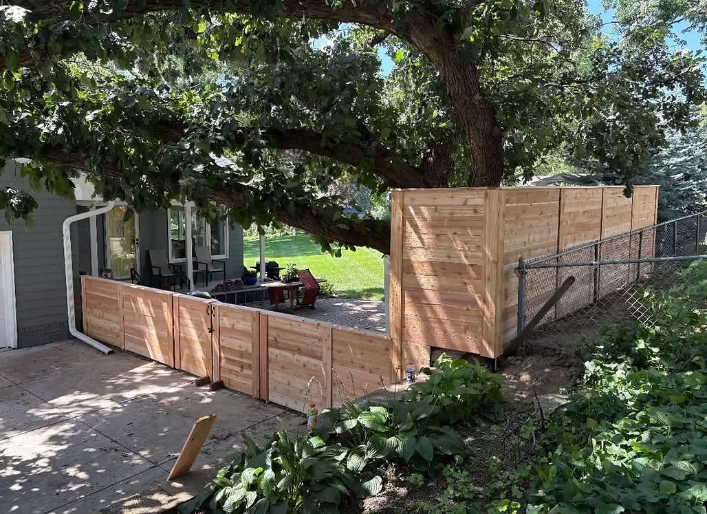 Custom wood privacy fence built around a patio and mature tree in Bellevue, NE Custom wood privacy fence built around a patio and mature tree in Bellevue, NE